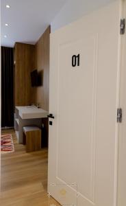 a bathroom with a white door and a sink at HM Boutique Hotel in Krujë