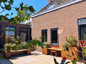 een bakstenen gebouw met een bank en enkele planten bij Hotel Loskade 45 in Middelburg