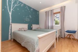 Cama ou camas em um quarto em Atlantic Nest Coimbra