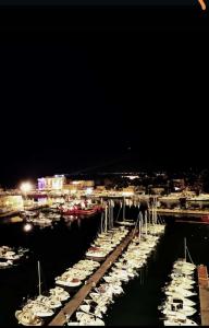 a group of boats docked in a marina at night at Sweet Home FCO Airport Roma in Fiumicino