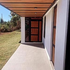 a door to a house with a wooden roof at Villa Baruch in San Juan Cosalá