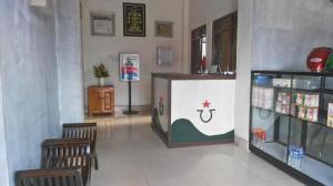 a shop with two chairs and a counter in a room at Avicenna Hotel in Palangkaraya