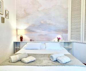 a bedroom with a bed with a painting on the wall at Aria di Collina - Isola d'Elba in Porto Azzurro