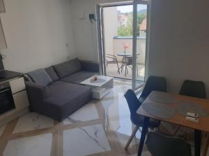 a living room with a couch and a table at PALAR Apartment in Ljubljana