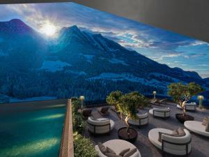 a view of a mountain from a resort with a swimming pool at Hotel Berghof - St Johann in Salzburg in Sankt Johann im Pongau