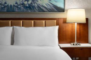 a bedroom with a bed and a lamp on a table at The Westin Chicago Northwest in Itasca