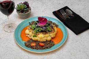 a plate of food on a table with a glass of wine at The Westin Chicago Northwest in Itasca