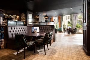 een eetkamer met een tafel en stoelen bij The Waterhead Inn- The Inn Collection Group in Ambleside