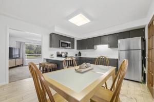 a kitchen and dining room with a table and chairs at Sunrise - 1322 Indian Point Road in Branson