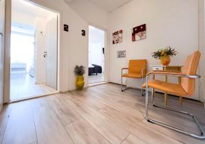 a living room with wooden floors and orange chairs at Weserstern in Bremen