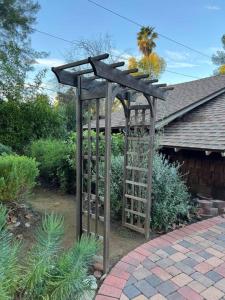 a wooden pergola in front of a house at Villa La Reforma - Newly Designed 4BR HOUSE & POOL in Los Angeles by Topanga in Los Angeles