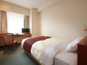 Tempat tidur dalam kamar di Hotel Pearl City Morioka