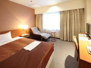 Tempat tidur dalam kamar di Hotel Pearl City Morioka