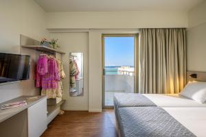 A bed or beds in a room at Marin Hotel