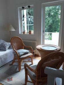 a bedroom with a bed and a chair and a window at Haus Vitsippan in Mariannelund