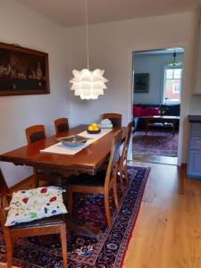 a dining room table with chairs and a chandelier at Haus Vitsippan in Mariannelund