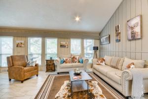 a living room with a couch and chairs and a table at Remote Texas Retreat Hot Tub, Deck, Grill! in Dalhart