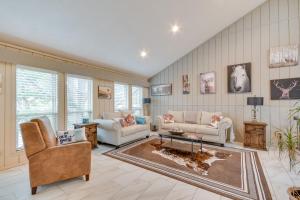 a living room with two couches and a table at Remote Texas Retreat Hot Tub, Deck, Grill! in Dalhart