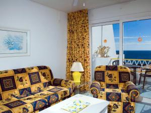 a living room with two couches and a table at BelleVue Aquarius in Puerto del Carmen