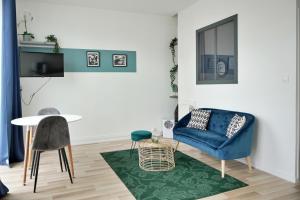 un soggiorno con tavolo e sedia blu di Studio Armorique Recouvrance a Brest