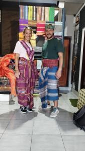 a man and a woman standing in front of a store at Hide and Seek in Tetebatu