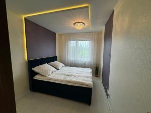 מיטה או מיטות בחדר ב-Bożki Apartament Kętrzyn