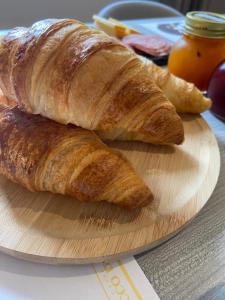 dos croissants en una tabla de cortar en una mesa en B&B Berninapass, en Poschiavo