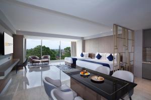 una camera con letto king-size e un soggiorno di Platinum Hotel Jimbaran Beach Bali a Jimbaran