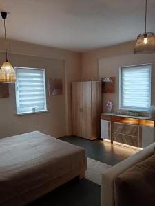 a bedroom with a bed and a television in it at Apartman ClaRa in Štúrovo