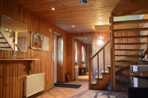 a hallway with wooden walls and stairs in a house at Guesthouse & sauna by HMTL in Liepāja