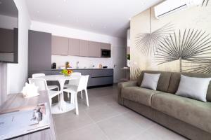 a living room and kitchen with a couch and a table at Residence Lido di Dante in Lido di Jesolo