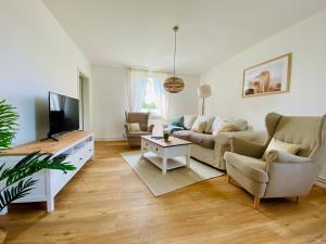 a living room with a couch and a tv at Ferienhaus Straußenblick in Bad Fallingbostel