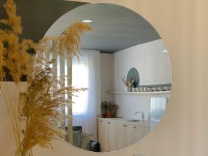 a mirror reflecting a bathroom with a sink and a counter at PROMO PRICE - Colorful by the sea - 1 min from the beach in Durrës