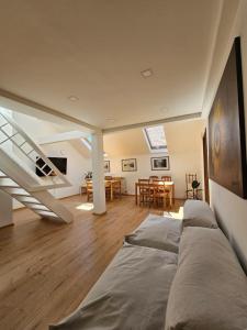 a living room with a couch and a staircase at Leopold Chillout Hostel in Sarajevo