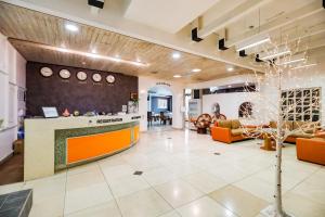 a lobby of a hospital with orange furniture at Newvera Hotel in Cheongju