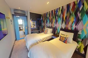 A bed or beds in a room at Village Hotel Basingstoke