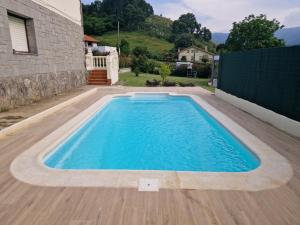 a swimming pool in a yard with a house at Casa La Quintana in Castro-Urdiales