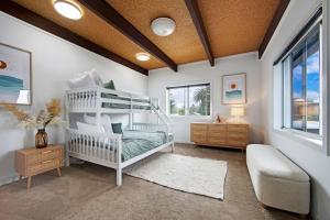 a bedroom with a white bunk bed and a window at Harbour Marina - Absolute waterfront apartment in Batemans Bay