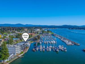 an aerial view of a marina with boats in the water at Harbour Marina - Absolute waterfront apartment in Batemans Bay