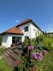 une maison avec terrasse et fleurs dans la cour dans l'établissement Vincent, à Luhačovice