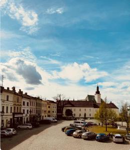 a parking lot with cars parked in front of buildings at Hotel Maxim in Frýdek-Místek