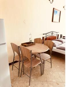 a table and chairs in a room with a bed at Hotel Maxim in Frýdek-Místek