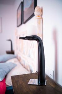 a black faucet on top of a wooden table at hotel rural GA7COLORES only adult in Montaña Blanca