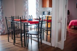 a dining room with a table with chairs and a kitchen at hotel rural GA7COLORES only adult in Montaña Blanca