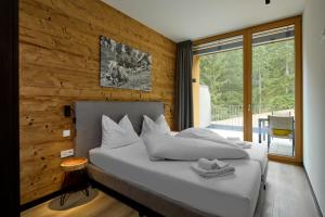 Cama ou camas em um quarto em Belvedere - Alpin-Resort Montafon Haus 3 by Pferd auf Wolke