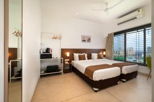 Rúm í herbergi á Freesia Residency By Express Inn - Navi Mumbai