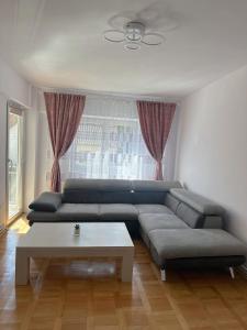 a living room with a couch and a coffee table at B7 Apartament in Ocna-Mureşului