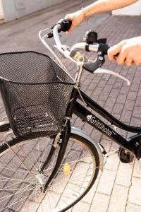 a person riding a bike with a basket at Hotel Gritti in Lido di Jesolo