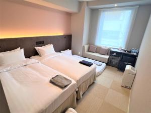 Voodi või voodid majutusasutuse Hiyori Hotel Osaka Namba Station toas