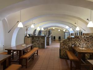 a restaurant with wooden tables and chairs and a counter at Wellness Hotel Svachovka in Český Krumlov